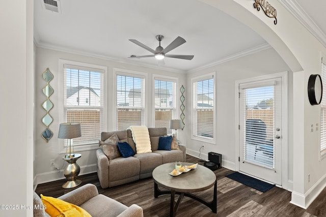 living room featuring ceiling fan, ornamental molding, and dark hardwood / wood-style floors