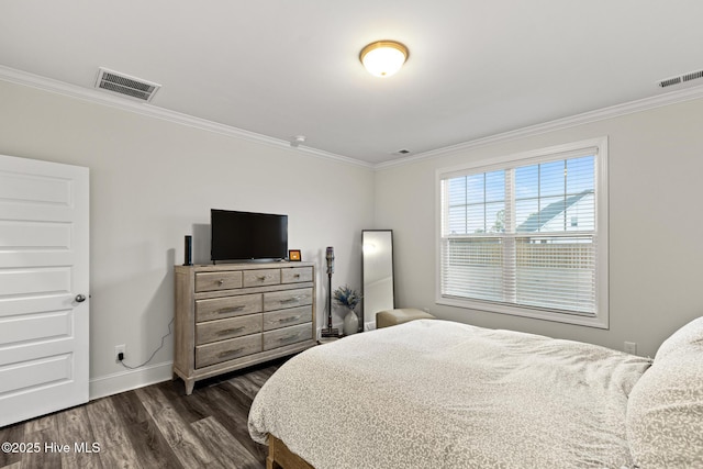 bedroom with ornamental molding and dark hardwood / wood-style floors