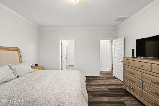 bedroom with crown molding, dark hardwood / wood-style floors, and ensuite bathroom