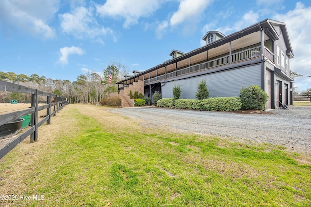 view of property exterior with a garage and a lawn