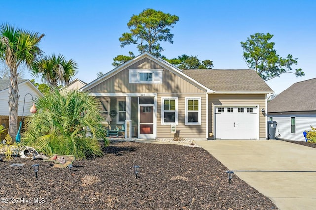 view of front facade with driveway, an attached garage, board and batten siding, and roof with shingles