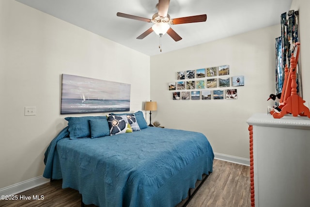 bedroom featuring ceiling fan, wood finished floors, and baseboards