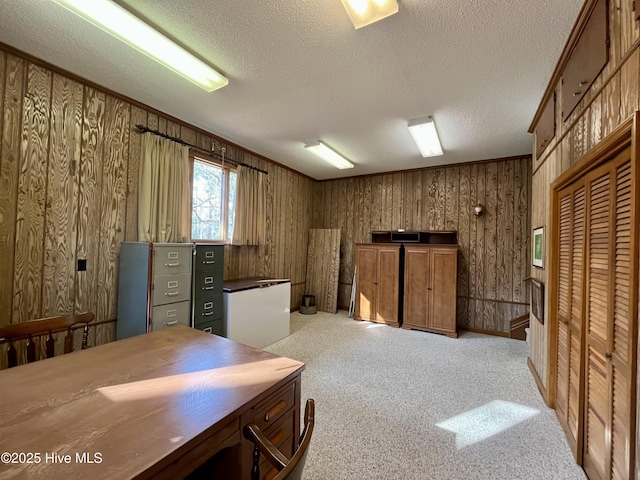 carpeted office featuring a textured ceiling