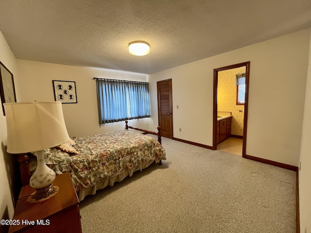 carpeted bedroom with a closet, connected bathroom, and a textured ceiling