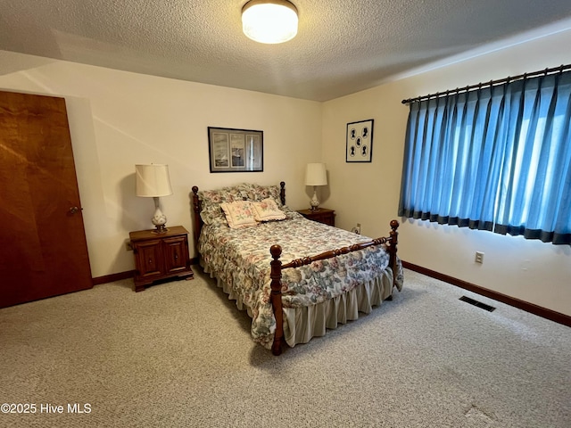 carpeted bedroom with a textured ceiling