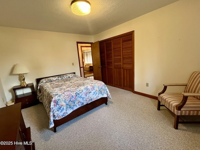 bedroom with carpet, a closet, and a textured ceiling