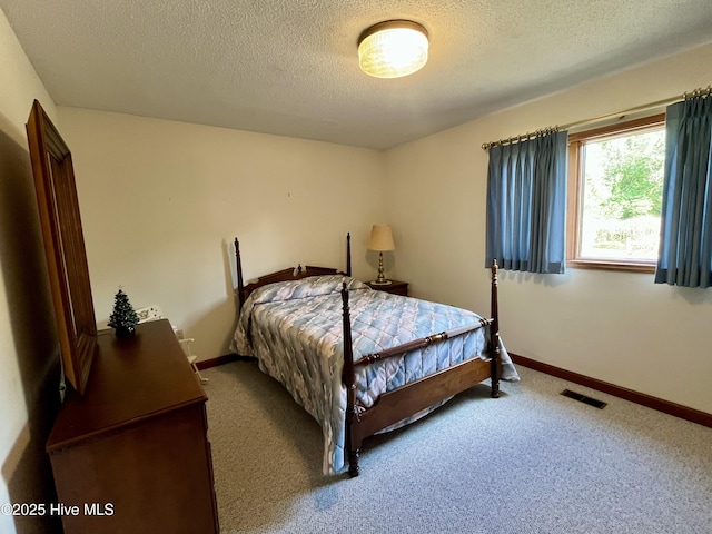 carpeted bedroom with a textured ceiling