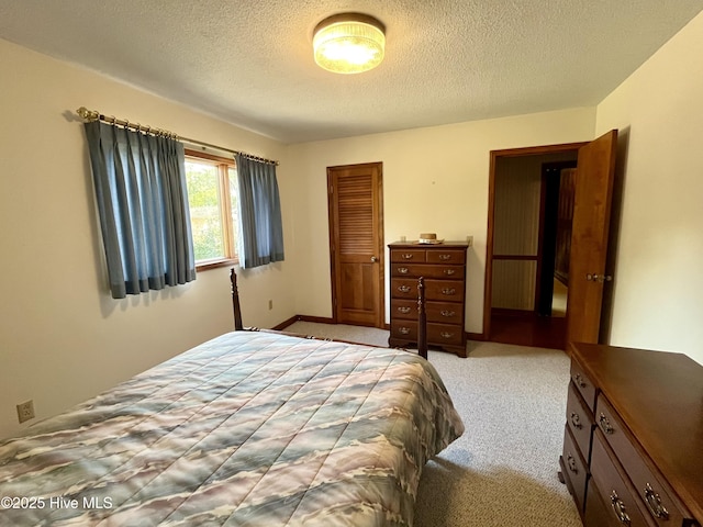 bedroom with light carpet, a textured ceiling, and a closet