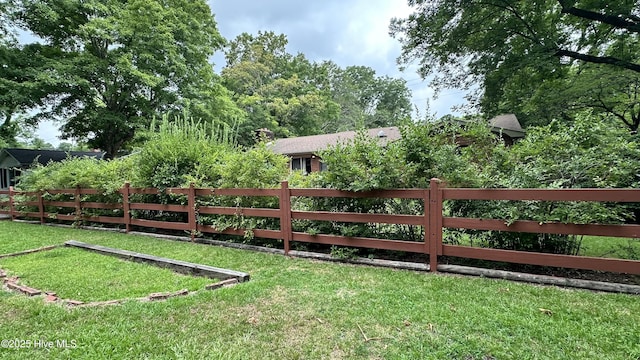 view of gate with a yard