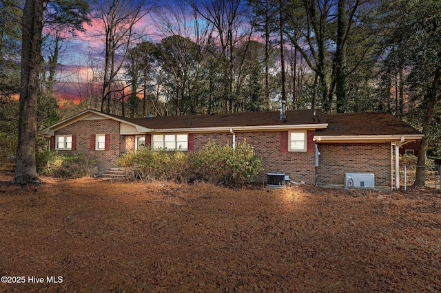 view of front of house with brick siding and central AC unit