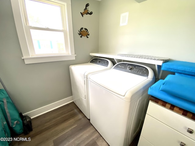 laundry area with dark hardwood / wood-style flooring and washer and dryer