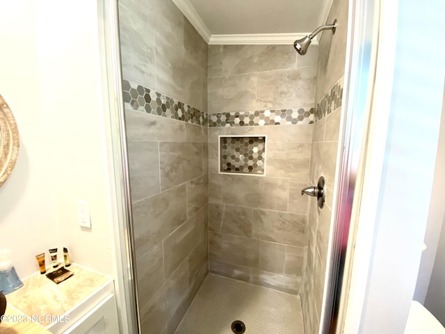 bathroom with crown molding and tiled shower