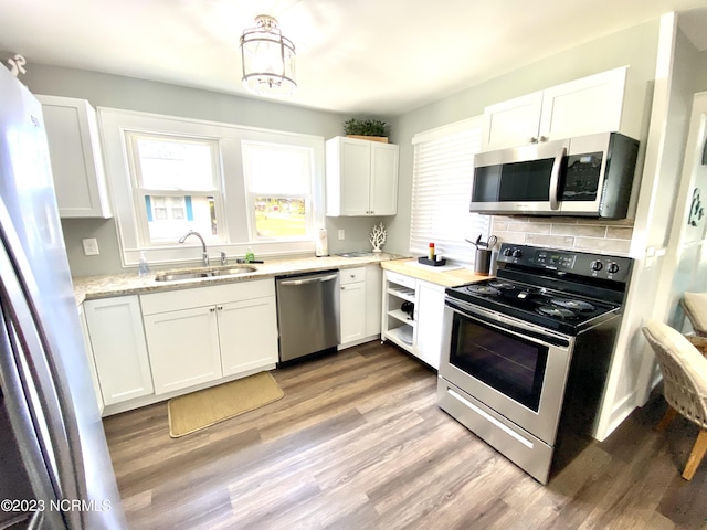 kitchen featuring white cabinetry, appliances with stainless steel finishes, and sink