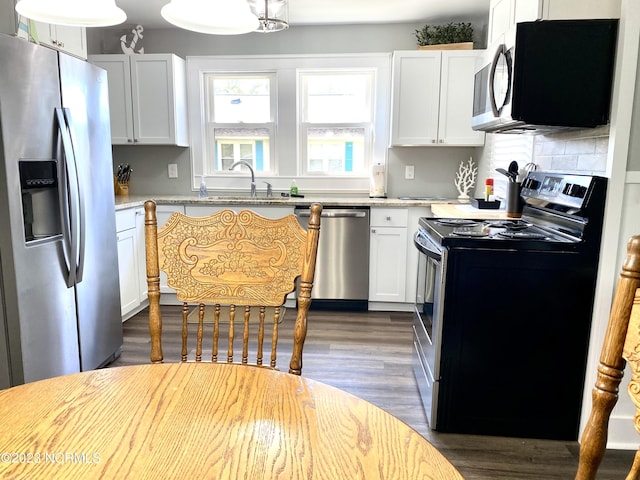 kitchen with sink, dark hardwood / wood-style floors, white cabinets, and appliances with stainless steel finishes