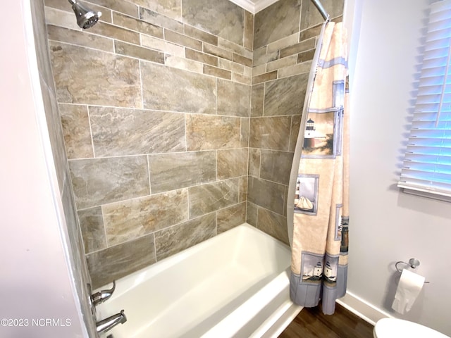 bathroom featuring wood-type flooring, shower / bath combination with curtain, and toilet