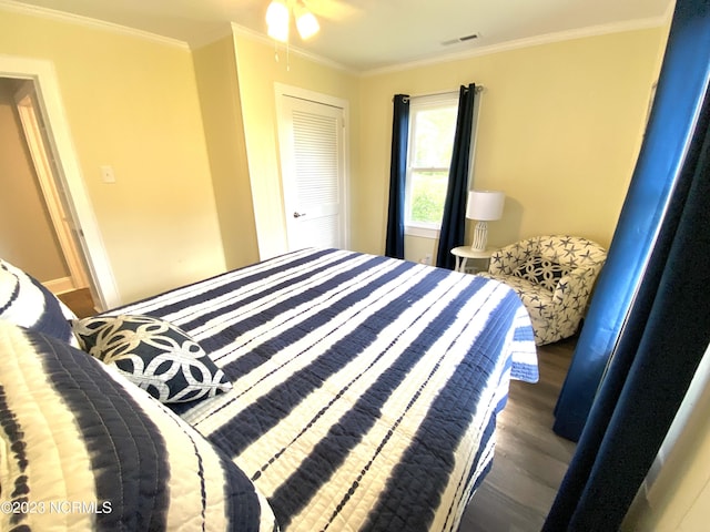 bedroom featuring crown molding and dark hardwood / wood-style floors