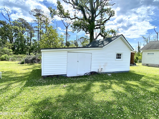 view of outbuilding featuring a lawn