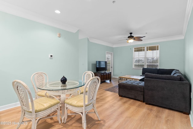 dining room featuring ceiling fan, ornamental molding, and light hardwood / wood-style flooring