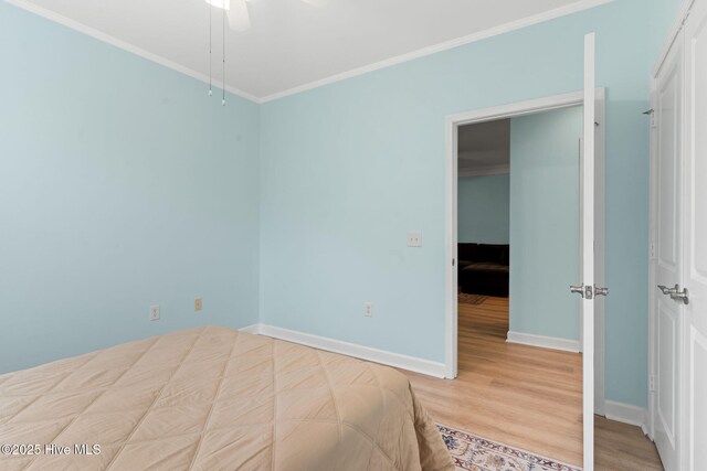 unfurnished bedroom featuring crown molding and light wood-type flooring