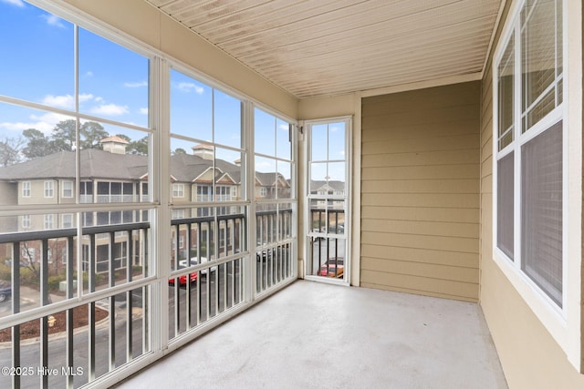 unfurnished sunroom with wood ceiling