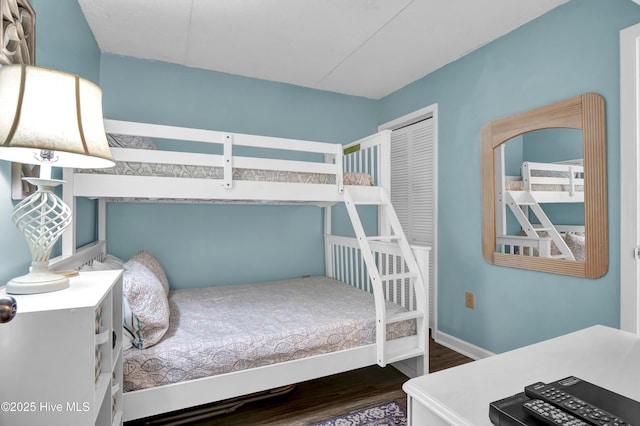 bedroom featuring dark wood-type flooring and a closet