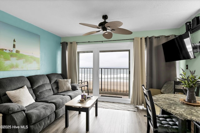 living room featuring light hardwood / wood-style flooring and ceiling fan