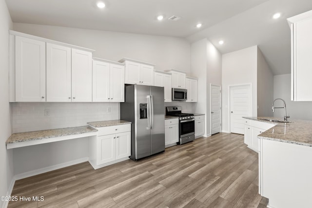 kitchen featuring a sink, light wood-type flooring, white cabinetry, and stainless steel appliances