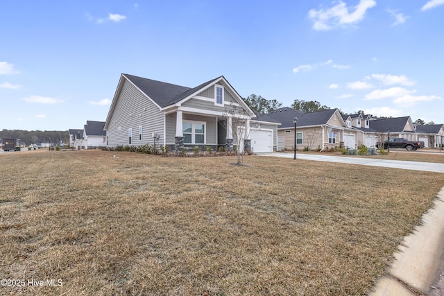 view of front of property featuring concrete driveway, a garage, a front yard, and a residential view