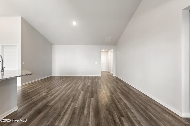 unfurnished living room featuring dark wood-style floors and baseboards