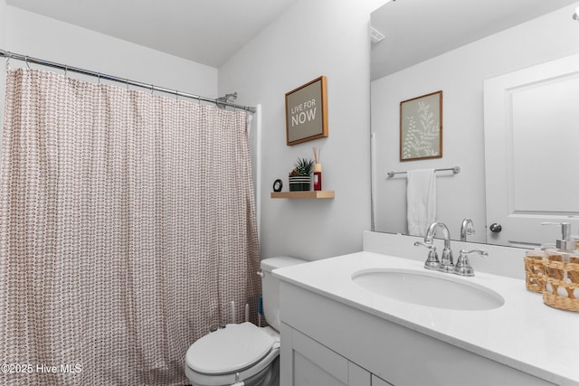 bathroom with vanity, toilet, and walk in shower