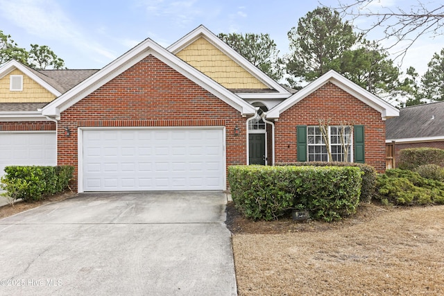 view of front of home with driveway, an attached garage, and brick siding