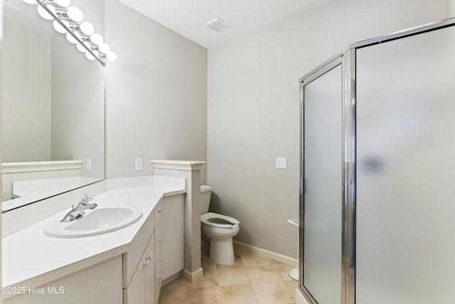 bathroom with a stall shower, vanity, toilet, and baseboards