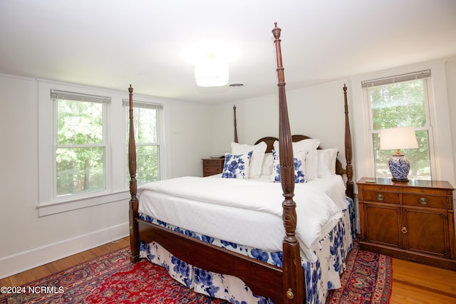 bedroom featuring multiple windows and light wood-type flooring