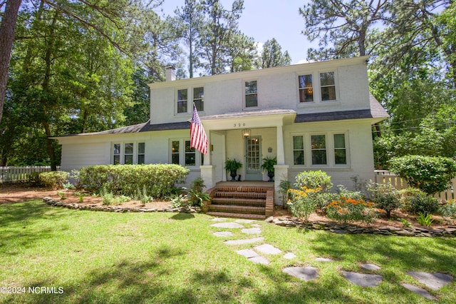 view of front facade with covered porch and a front lawn