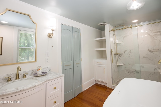 bathroom with vanity, wood-type flooring, and a shower with shower door