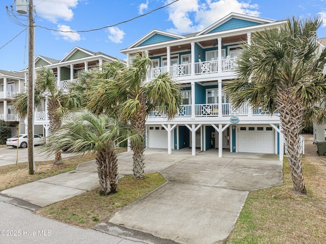 raised beach house featuring a carport, a garage, and a balcony