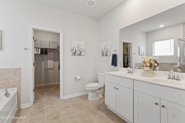 bathroom featuring vanity, a bathtub, tile patterned floors, and toilet