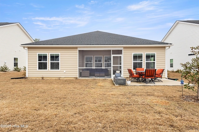 rear view of house featuring a patio, a sunroom, and a yard