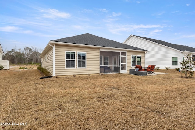 rear view of property featuring a sunroom, a yard, and a patio area