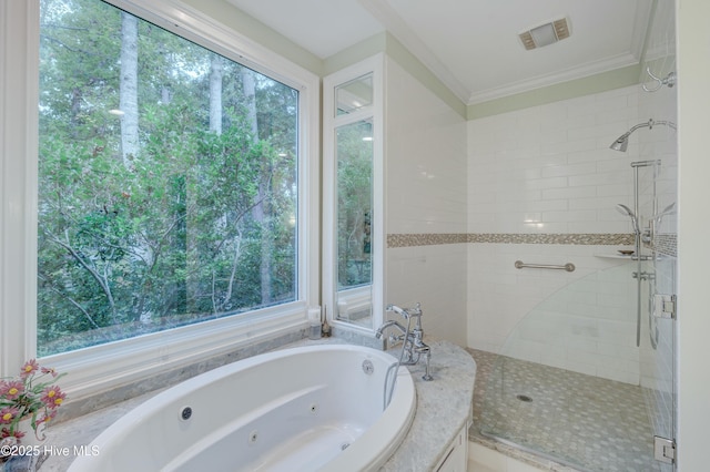 bathroom with ornamental molding and shower with separate bathtub