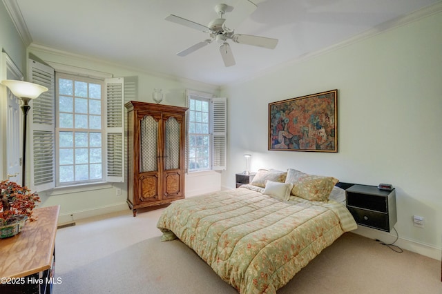 bedroom with multiple windows, crown molding, light colored carpet, and ceiling fan