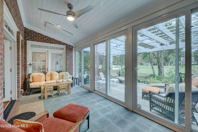 sunroom with vaulted ceiling, ceiling fan, and wood ceiling