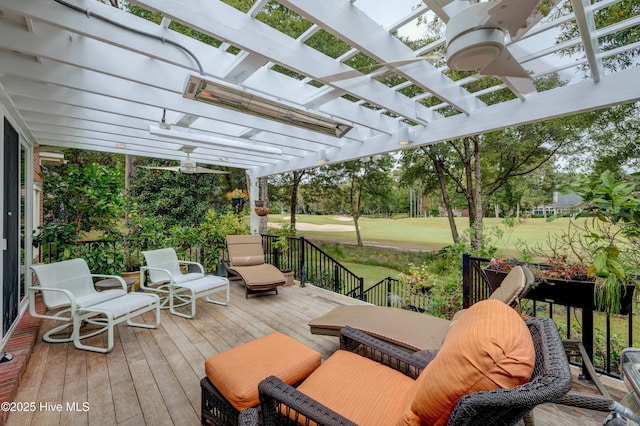 wooden deck featuring a lawn and a pergola