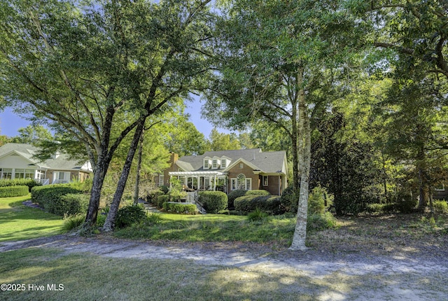 view of front facade with a pergola and a front yard