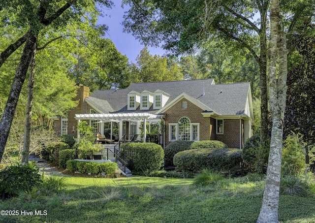 new england style home with a pergola and a front lawn