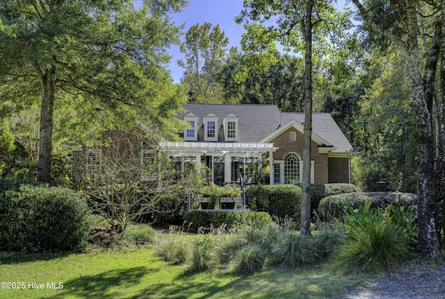 new england style home with a pergola