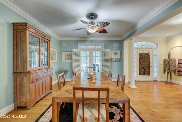 dining area with crown molding, ceiling fan, light hardwood / wood-style floors, french doors, and ornate columns