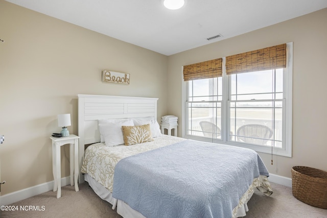 carpeted bedroom with visible vents and baseboards