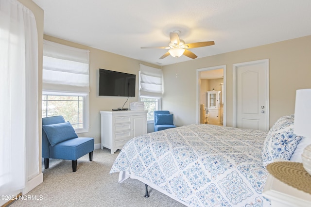 bedroom featuring a ceiling fan and light colored carpet