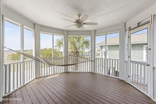 unfurnished sunroom with plenty of natural light and ceiling fan